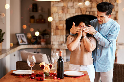 Buy stock photo Couple surprise, romantic home dinner and man cover woman's eyes for fine dining, red wine or Valentines day date. Marriage anniversary love, rose petals and happy people celebrate holiday event