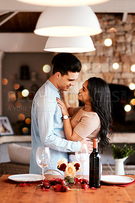 Buy stock photo Love, smile and romance, couple hug on valentines day date at home with wine, rose petals and bokeh. Date night, man and woman in living room, valentine celebration and happy relationship together.