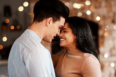 Buy stock photo Love, romance and couple hugging while on a date for valentines day or anniversary celebration. Happy, intimate and young interracial man and woman embracing while at romantic evening dinner together