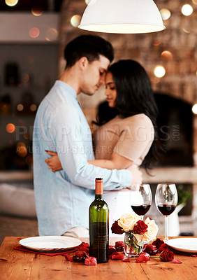 Buy stock photo Love, wine and romance, couple hug on valentines day date at home with rose petals and bokeh. Date night, man and woman embrace in living room, valentine celebration and happy relationship together.