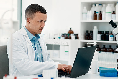 Buy stock photo Shot of a young scientist using a laptop while working in a laboratory