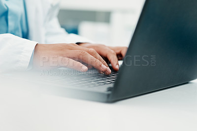Buy stock photo Cropped shot of a scientist using a laptop while working in a laboratory