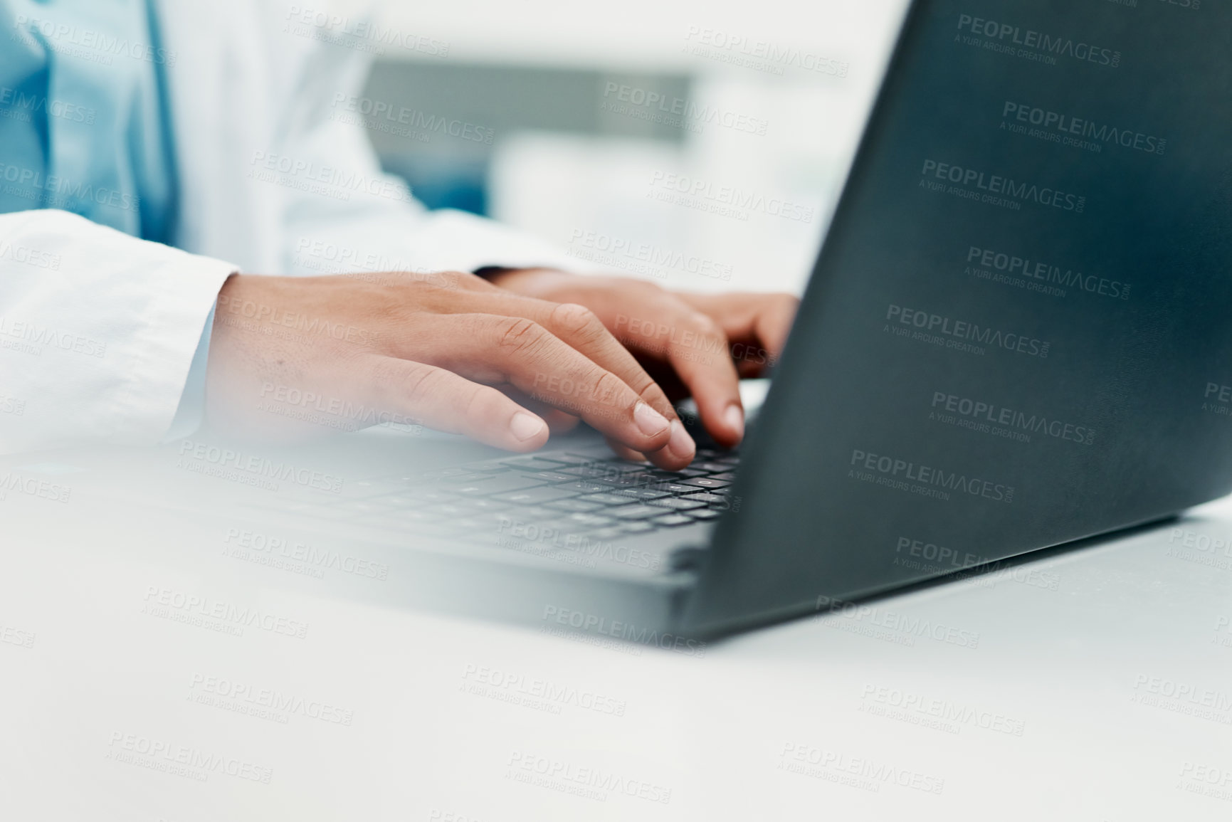 Buy stock photo Cropped shot of a scientist using a laptop while working in a laboratory