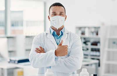 Buy stock photo Portrait of a confident young scientist showing thumbs up in a modern laboratory