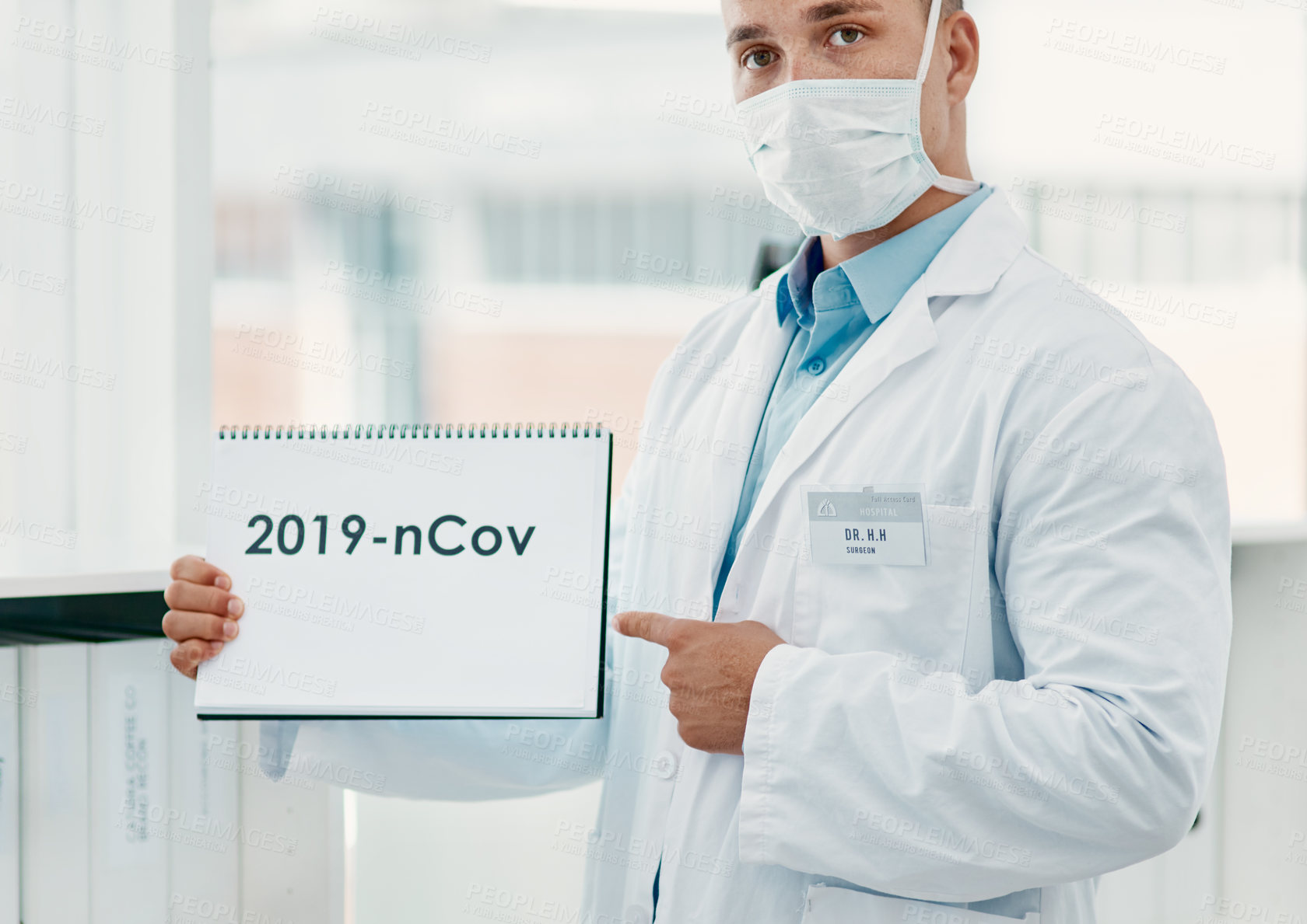 Buy stock photo Man, portrait and doctor with sign for covid, pandemic or year of virus or date at hospital. Male person, medical worker or healthcare employee with warning, page or paper for post or pre coronavirus