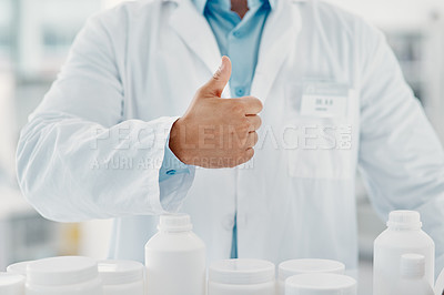 Buy stock photo Cropped shot of a scientist showing thumbs up in a modern laboratory