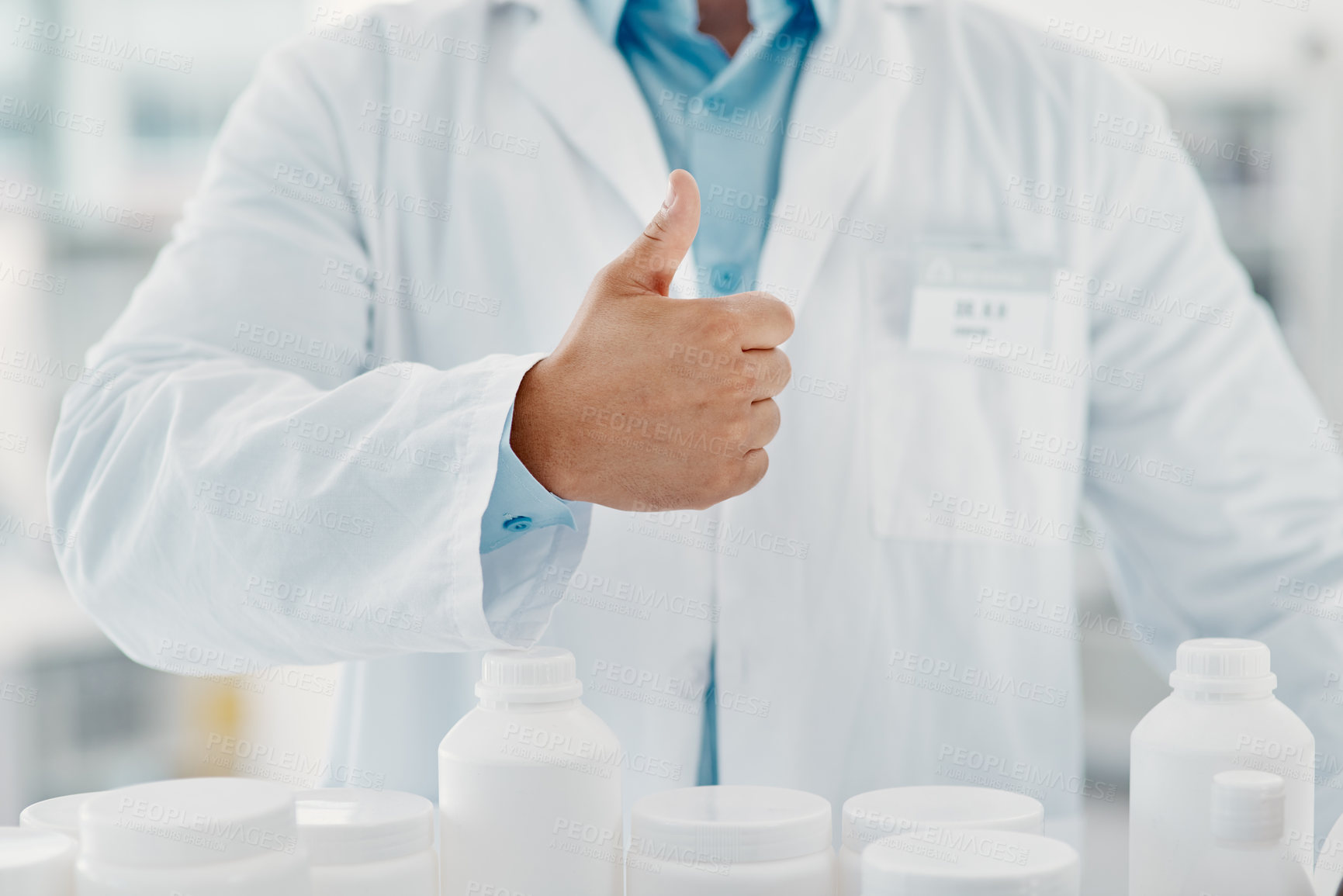 Buy stock photo Cropped shot of a scientist showing thumbs up in a modern laboratory