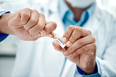 Buy stock photo Cropped shot of a scientist opening an ampoule with 2019-nCov on it