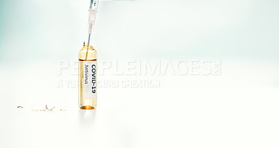 Buy stock photo Shot of a syringe extracting medication from an ampoule with 2019-nCov on it