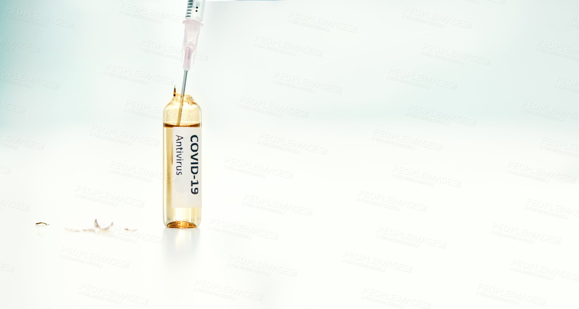 Buy stock photo Shot of a syringe extracting medication from an ampoule with 2019-nCov on it