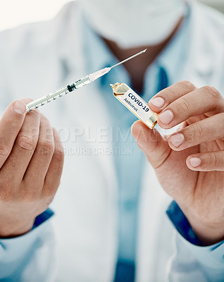 Buy stock photo Shot of a scientist extracting medication using a syringe from an ampoule with 2019-nCov on it