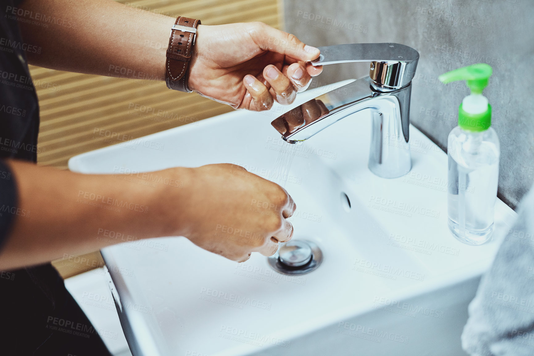 Buy stock photo Cropped shot of an unrecognisable man washing his hands in the bathroom sink
