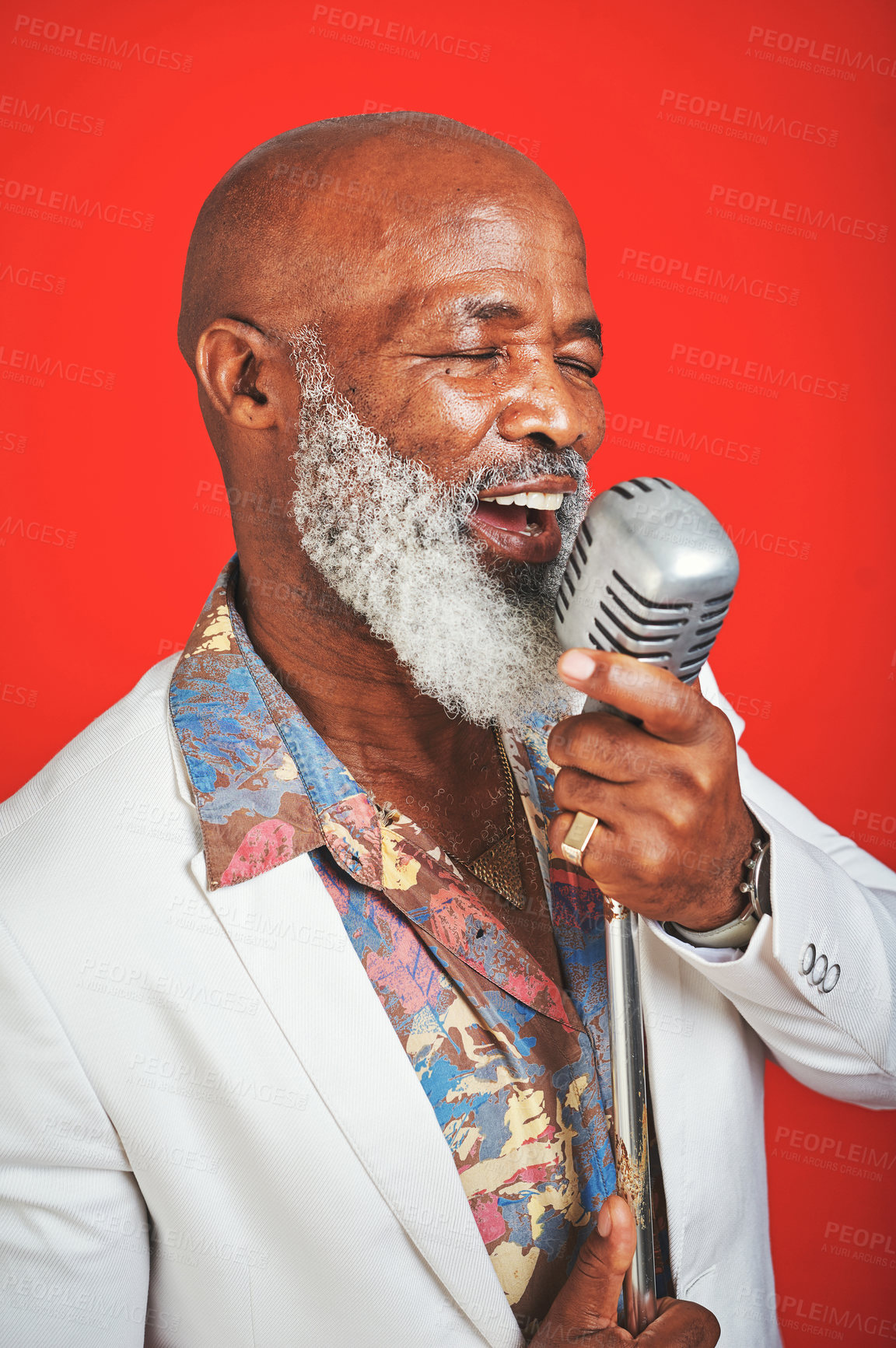 Buy stock photo Singer, senior and black man on microphone with soul, jazz and old school music with retro style in studio. Musician, cool and singing with blues song in groovy and vintage fashion and red background