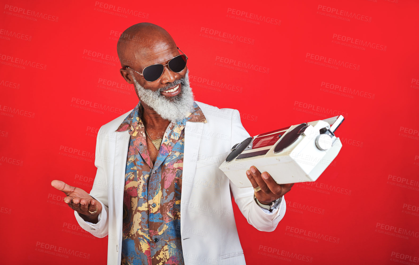 Buy stock photo Fashion, mature man or happy with radio in studio with confidence, sunglasses or vintage outfit. Retro aesthetic, black person or hipster style on red background with boombox for soul music on mockup