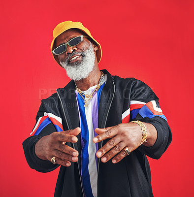 Buy stock photo Senior black man, fashion and rings with vintage style for trendy casual outfit in studio on red background. African person, confident and accessory for cool retro clothes, attitude or sunglasses