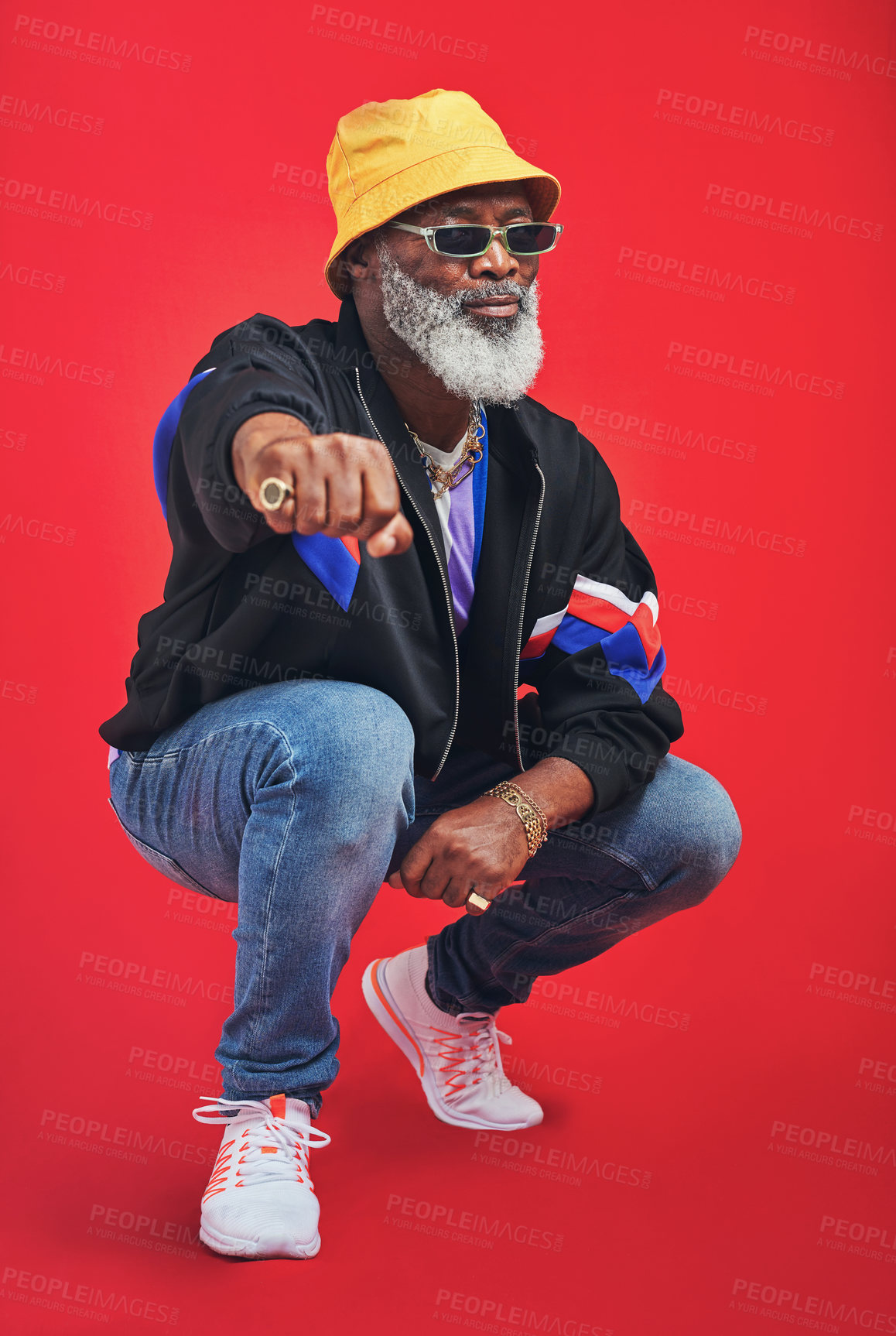 Buy stock photo Studio shot of a senior man wearing retro attire while posing against a red background