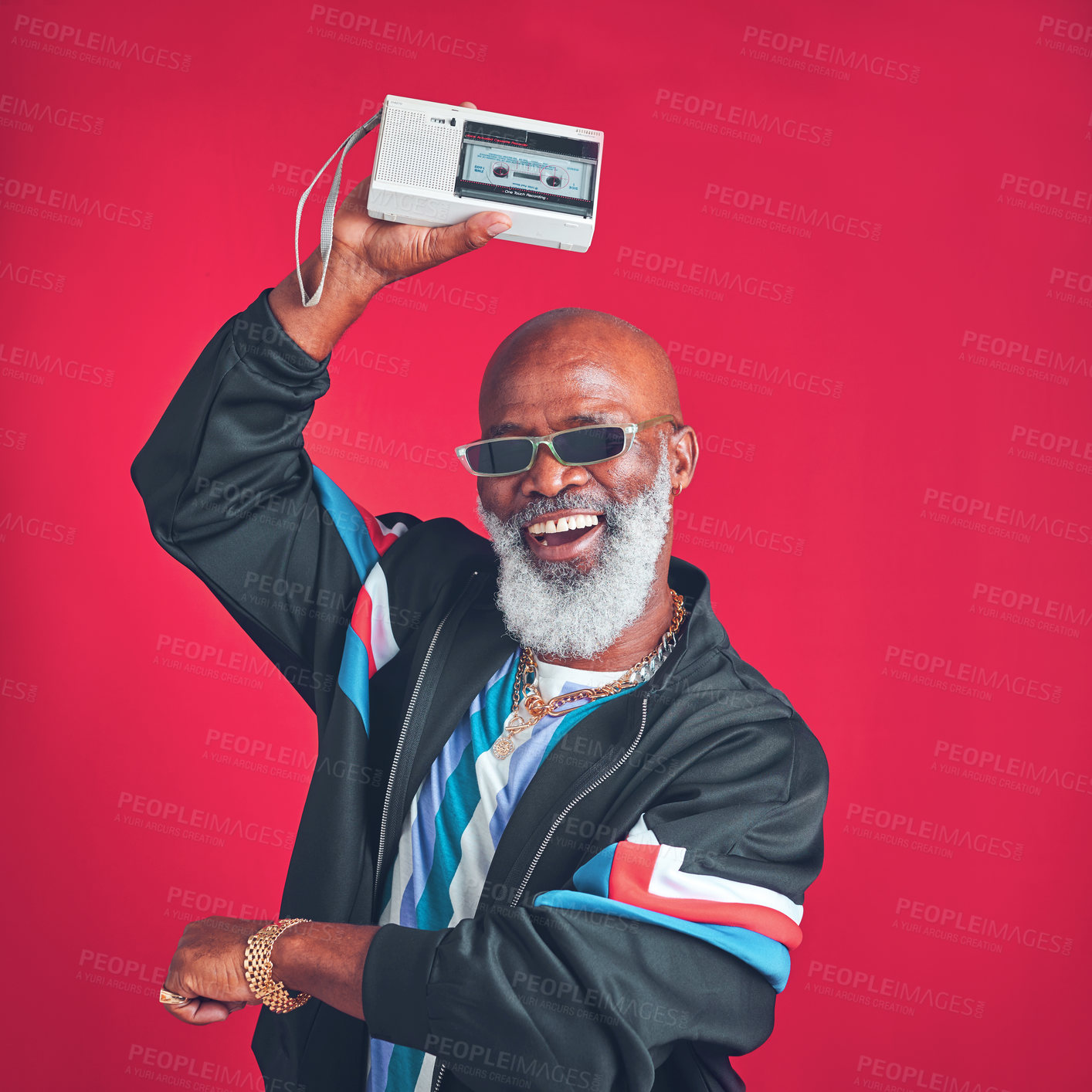 Buy stock photo Senior, happy man or radio in retro fashion with streetwear, trendy sunglasses or dance in studio. African model, audio stereo or vintage style on red background with cassette player for soul music