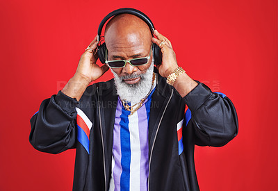 Buy stock photo Senior, black man or headphones in retro fashion with streetwear, trendy sunglasses or radio in studio. African guy, elderly person or vintage style on red background with audio track for soul music