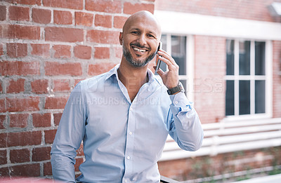 Buy stock photo Shot of a mature businessman using a smartphone outside of a modern office