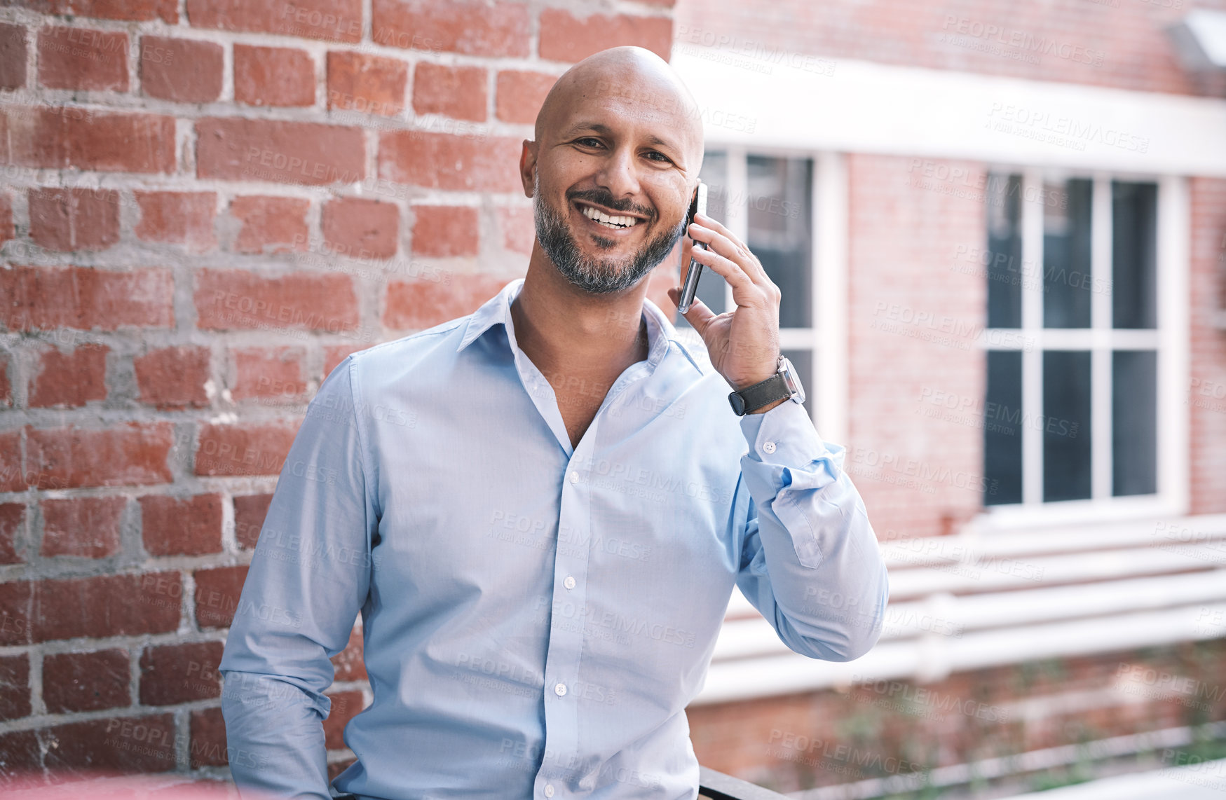 Buy stock photo Shot of a mature businessman using a smartphone outside of a modern office