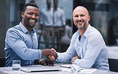 Buy stock photo Shot of two businessmen shaking hands during a meeting