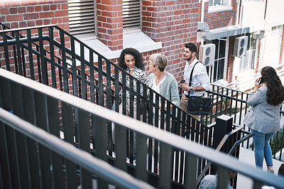 Buy stock photo Shot of a group of businesspeople walking up the stairs in a modern workplace