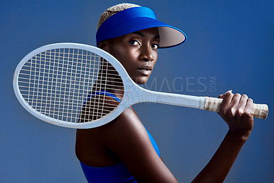 Buy stock photo Fitness, fashion and black woman with tennis racket in studio for training, workout or match with athlete. Portrait, style and African sport player with confidence for practice by blue background.