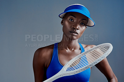 Buy stock photo Black woman, portrait or sports player with tennis racket for fitness or tournament on a blue studio background. Young African, female person or serious athlete with bat for game, match or challenge