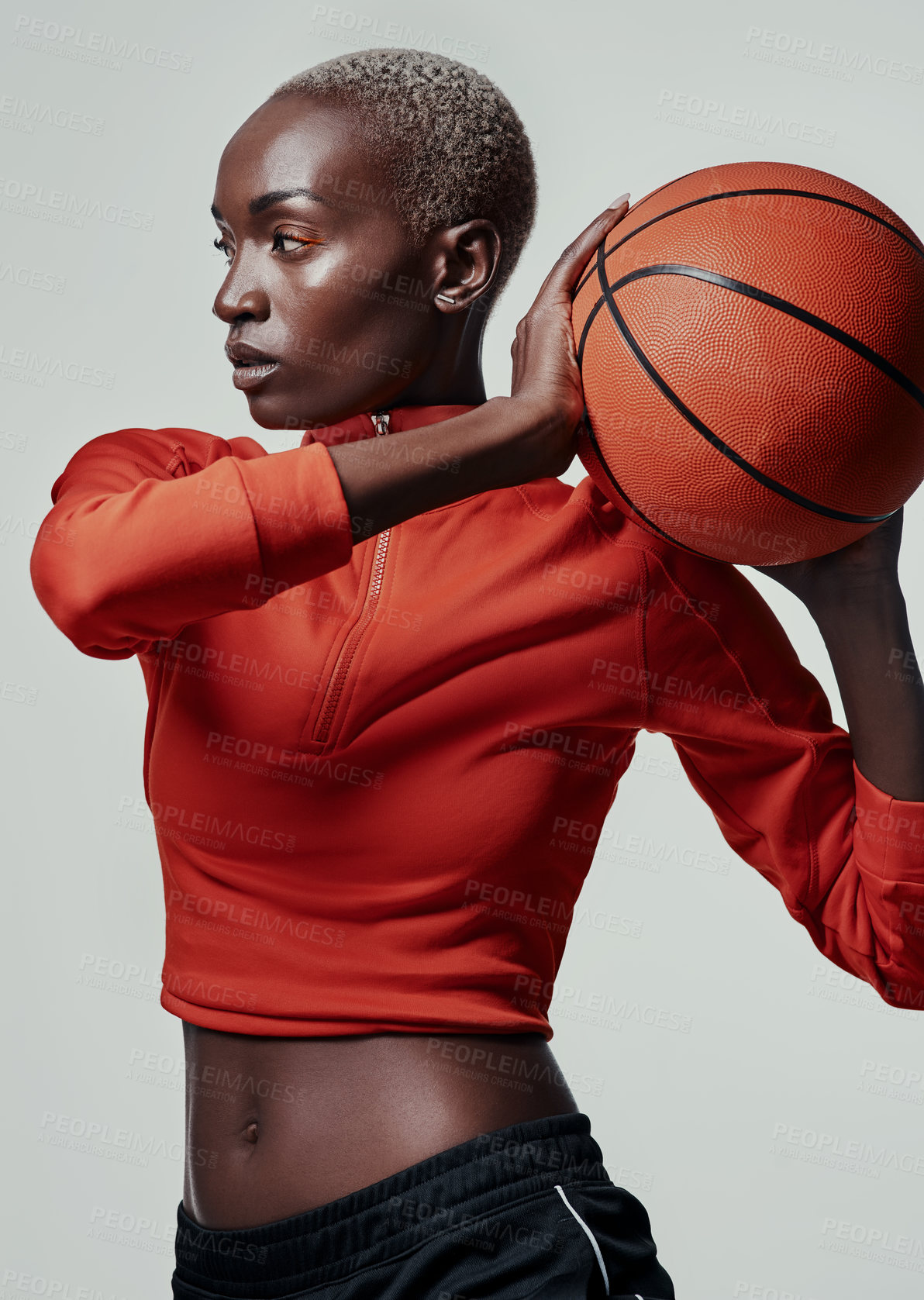 Buy stock photo Studio shot of an attractive young woman playing basketball against a grey background