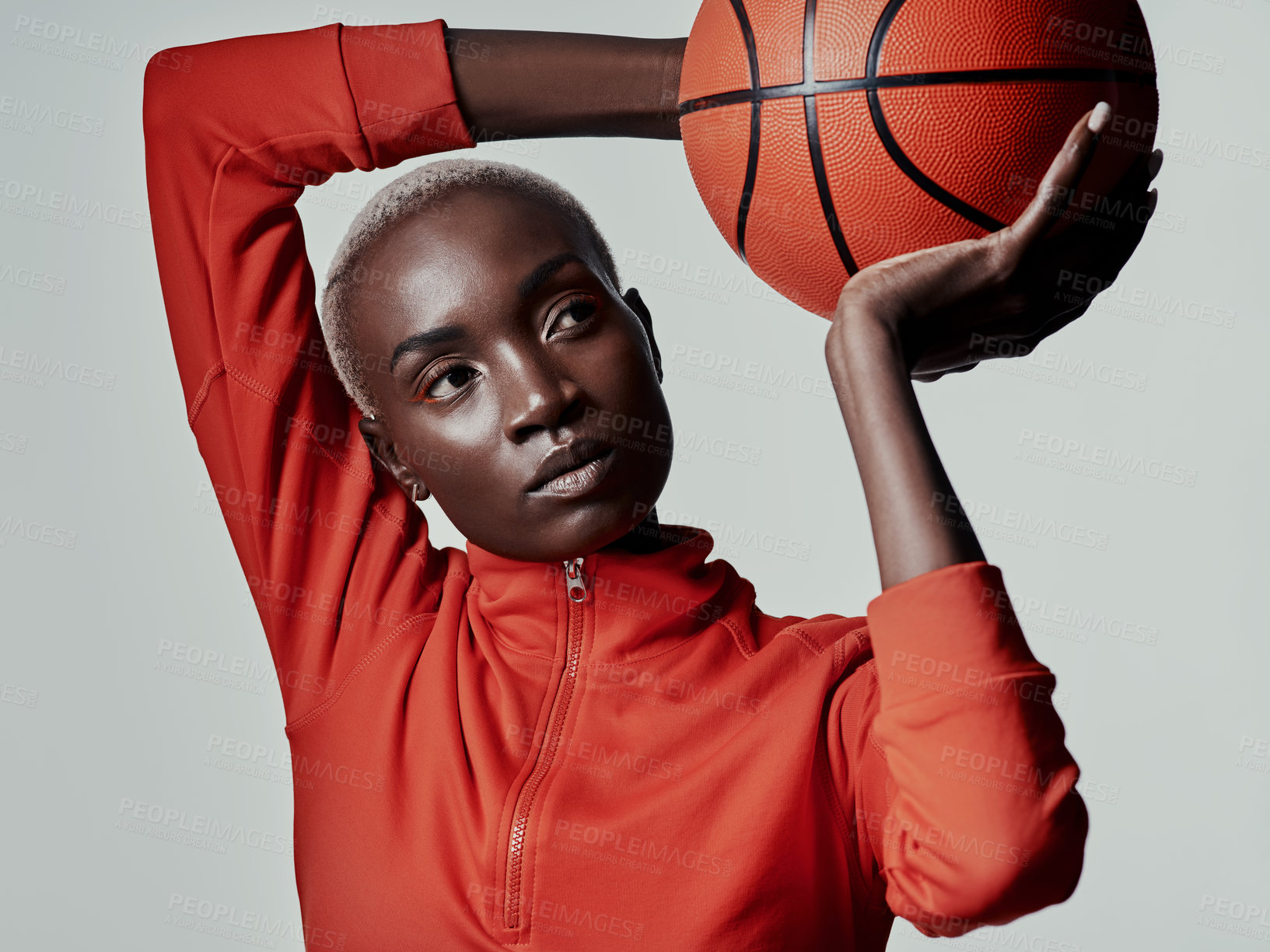 Buy stock photo Studio shot of an attractive young woman playing basketball against a grey background