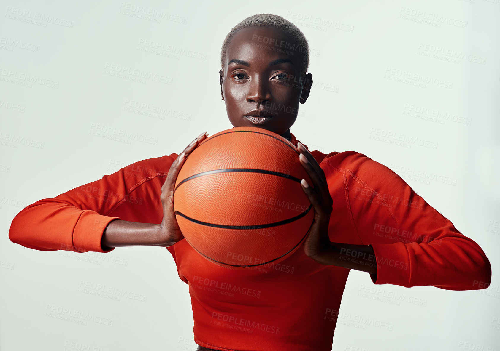 Buy stock photo Studio shot of an attractive young woman playing basketball against a grey background