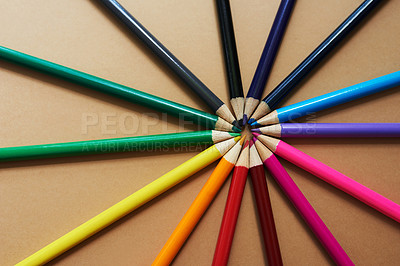 Buy stock photo Studio shot of different coloured pencils against a brown background