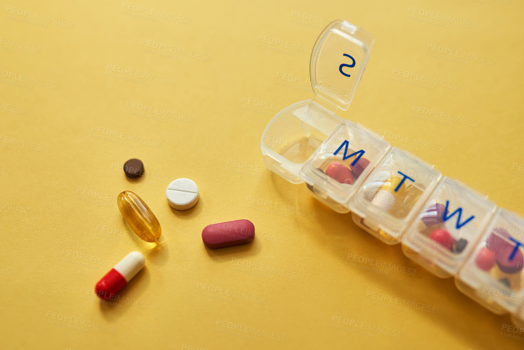 Buy stock photo Medicine, pills and weekly container in studio for healthcare routine, medical reminder and prescription. Drugs, collection and tablets storage, management and treatment schedule on yellow background