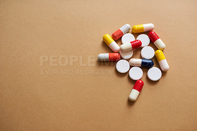 Buy stock photo Studio shot of a pile of different tablets against a brown background