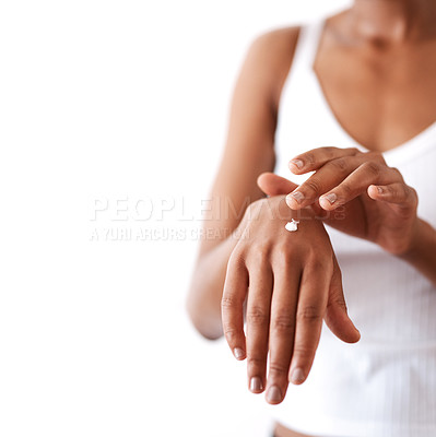 Buy stock photo Studio shot of an unrecognizable woman moisturising her hands