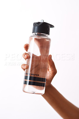 Buy stock photo Studio shot of an unrecognizable woman holding a water bottle against a white background