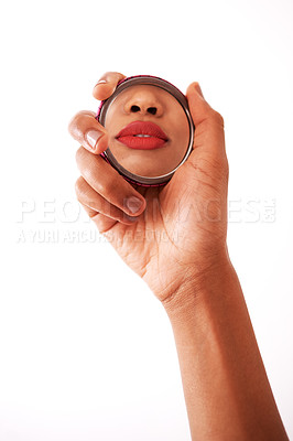 Buy stock photo Studio shot of an unrecognizable woman holding a pocket size mirror against a white background