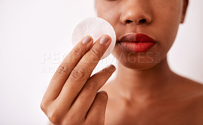 Buy stock photo Studio shot of an unrecognizable woman using a cotton pad to remove her lipstick