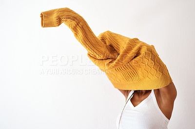 Buy stock photo Studio shot of an unrecognizable woman getting dressed against a white background