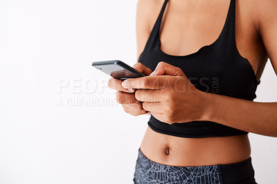 Buy stock photo Studio shot of an unrecognizable woman using her cellphone against a white background
