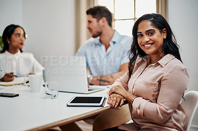 Buy stock photo Shot of a young businesswoman using a digital tablet during a meeting in a modern office