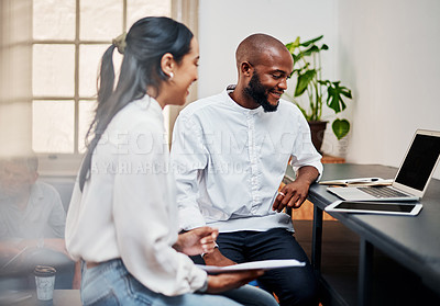 Buy stock photo Shot of a young businessman and businesswoman using a laptop during a meeting in a modern office