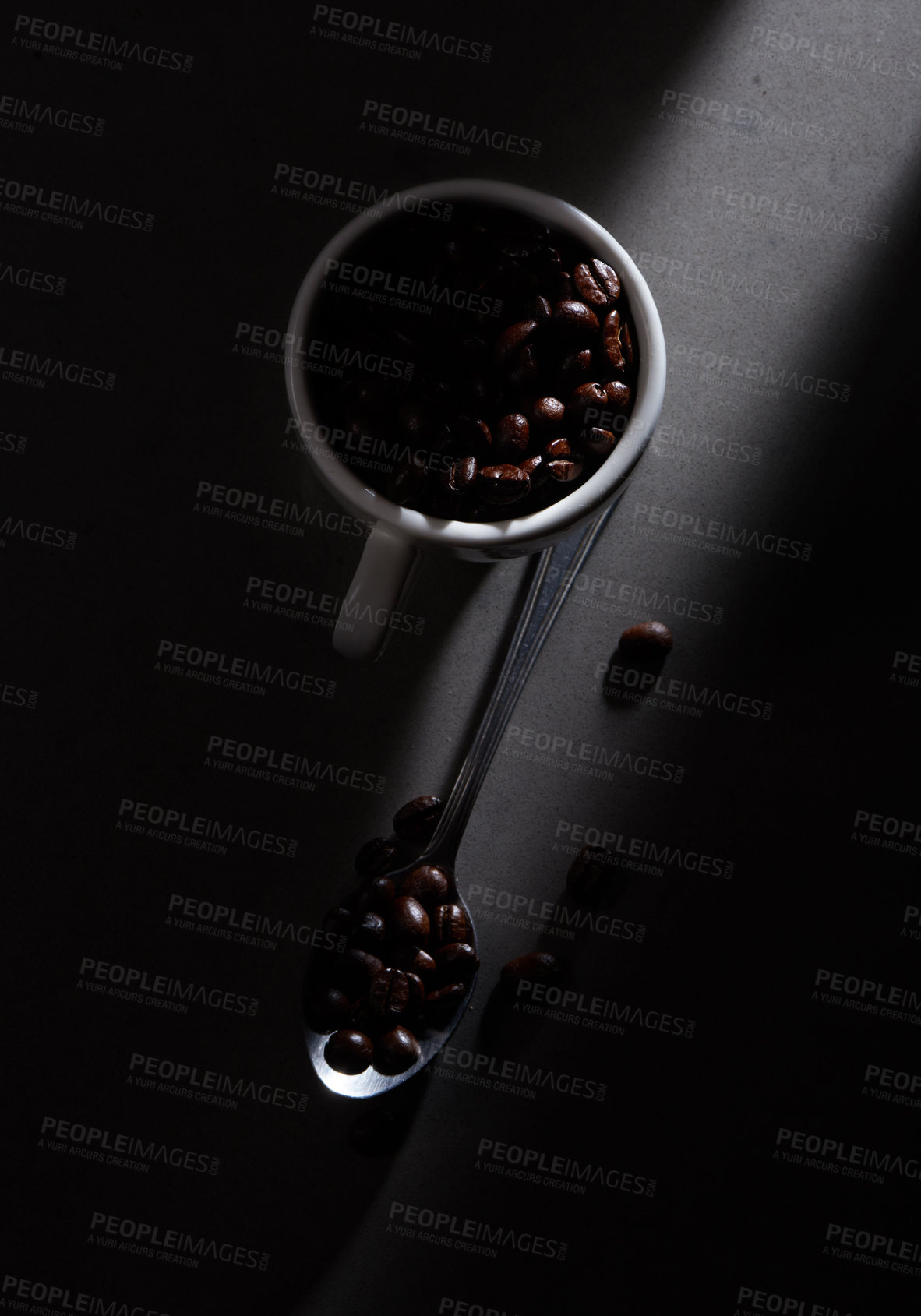 Buy stock photo Studio shot of coffee beans in a cup and on a spoon