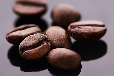 Buy stock photo Studio shot of coffee beans against a grey background