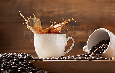 Buy stock photo Coffee, mug and beans with splash of caffeine or ingredient at cafe for espresso, cappuccino or latte at shop. Closeup, cocoa or organic seeds with cup, spill or liquid for dark roast, blend or brew