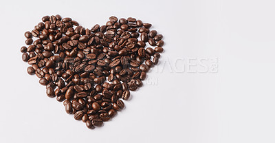 Buy stock photo Studio shot of coffee beans shaped in a heart against a white background