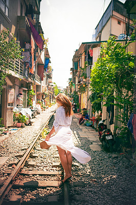 Buy stock photo Travel, walking and back of woman on train tracks for holiday, vacation and adventure in Vietnam. Fashion, street and person on railway for journey, tourist destination and sightseeing in urban city