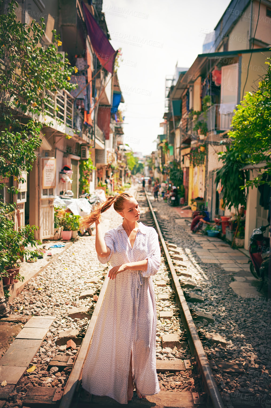 Buy stock photo Travel, fashion and woman on train tracks in city for holiday, vacation and adventure in Vietnam. Walking,  street and person on railway for journey, tourist destination and sightseeing in urban town