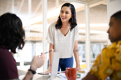 Buy stock photo Shot of a young businesswoman having a discussion with her colleagues in an office