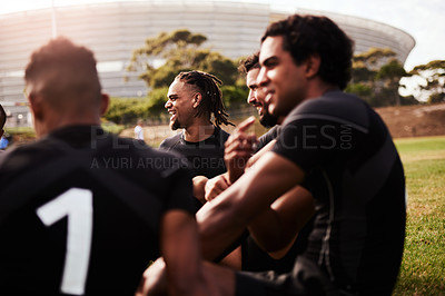 Buy stock photo Shot of a group of young rugby players having a discussion on the field